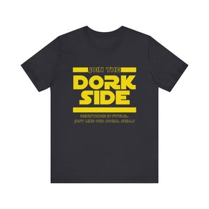 May include: Black t-shirt with a yellow graphic that says "Join the Dork Side" with the text "Resistance is futile... Just like our social skills" underneath.