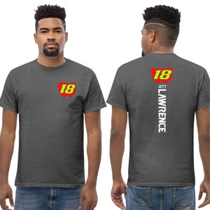 May include: A heather grey t-shirt with a red and yellow number 18 on the front and the text "Jett Lawrence" and the number 18 on the back.