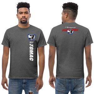 May include: A heather grey t-shirt with a white graphic of Eli Tomac's racing number 3. The back of the shirt has the text "The Original Beast Mode" with the number 3 in a blue and white circle.