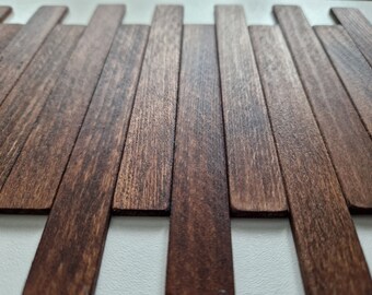 May include: A close-up of a wooden wall panel made of thin, dark brown wood strips arranged in a horizontal pattern.