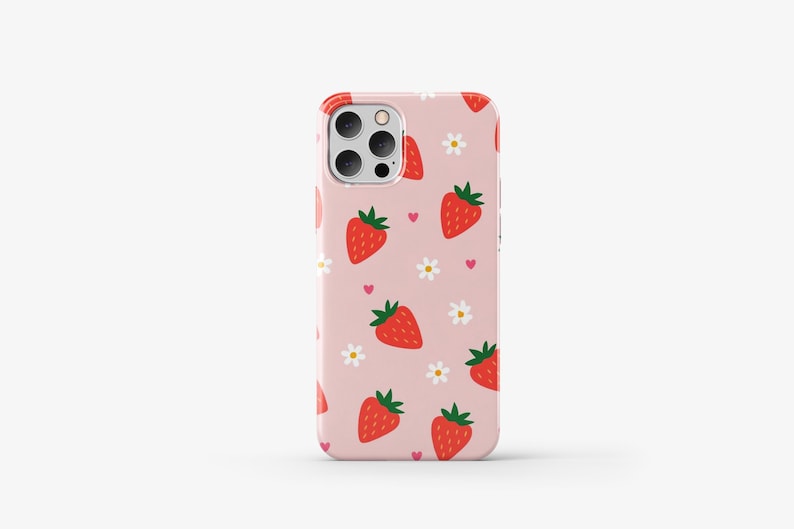 May include: A pink phone case with a pattern of red strawberries, white flowers, and pink hearts.