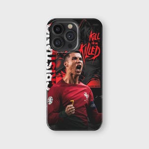May include: Black phone case featuring a red and black graphic of a soccer player in a red jersey. The case has the text "CRISTIANO" and "KILL OR BE KILLED". The player is celebrating with his mouth open.