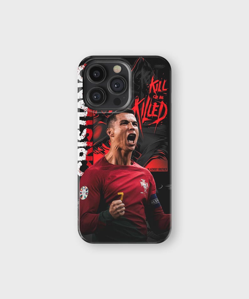 May include: Black phone case featuring a red and black graphic of a soccer player in a red jersey. The case has the text "CRISTIANO" and "KILL OR BE KILLED". The player is celebrating with his mouth open.