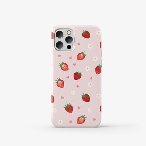 May include: A pink phone case with a pattern of strawberries and hearts. The case has a clear camera cutout and a white border.