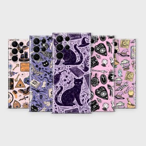 May include: A collection of five phone cases with unique, repeating patterns. The cases feature illustrations of cats, stars, Ouija boards, and other mystical symbols in shades of black, purple, and pink. The cases are arranged in a row against a light gray background.