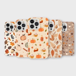 May include: Five phone cases with fall-themed designs. The cases feature patterns of pumpkins, leaves, acorns, and coffee cups in shades of orange, brown, and beige. The cases are arranged in a row, showcasing the variety of autumn-inspired graphics.