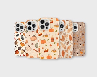 May include: Five phone cases with fall-themed designs. The cases feature patterns of pumpkins, leaves, acorns, and coffee cups in shades of orange, brown, and beige. The cases are arranged in a row, showcasing the variety of autumn-inspired graphics.