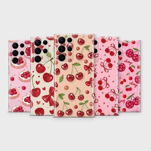 May include: Five phone cases with cherry designs. The cases feature various patterns, including cherries with bows, cherries on pink backgrounds, and cherries with hearts. The cases are in a row, showcasing the different designs.