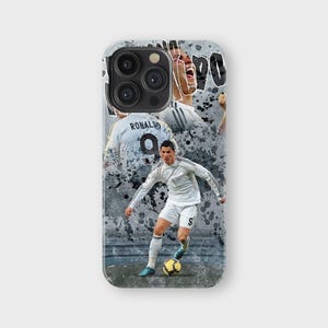 May include: A phone case featuring a collage of a soccer player in a white uniform with the number 9. The design includes action shots and the name "Ronaldo" on the back of the jersey, set against a gray, textured background.