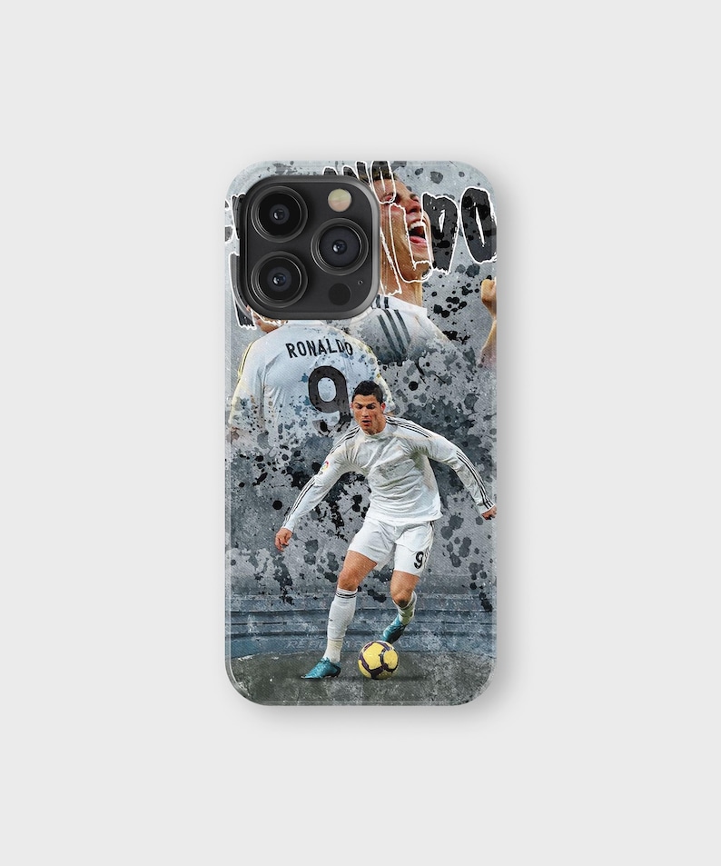 May include: A phone case featuring a collage of a soccer player in a white uniform with the number 9. The design includes action shots and the name "Ronaldo" on the back of the jersey, set against a gray, textured background.