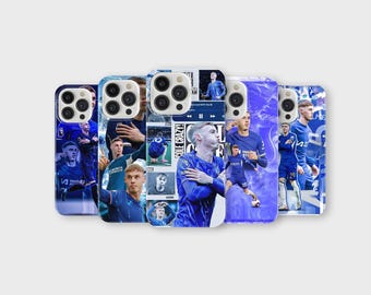 May include: A collection of phone cases featuring images of soccer players in blue uniforms. The cases display various action shots and portraits of the athletes. The background is a mix of blue and white tones.