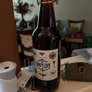 May include: A set of three ceramic mugs with a speckled, matte finish. The mugs are in shades of cream, light gray, and dark gray. Each mug has a simple, minimalist design, perfect for coffee or tea.