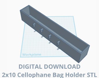May include: A 3D model of a 2x10 cellophane bag holder. The holder is a gray rectangular box with a series of small hooks on the inside. The model is shown on a grid background.