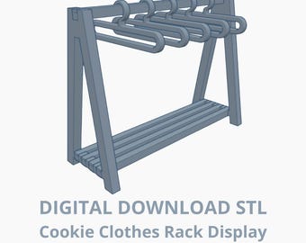 May include: A light blue cookie clothes rack display with a slatted shelf and integrated hangers. The rack is made of wood and has a simple, modern design. The text "DIGITAL DOWNLOAD STL Cookie Clothes Rack Display" is at the bottom.