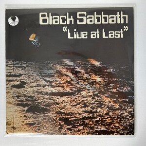 May include: Black Sabbath "Live at Last" vinyl record cover featuring a black and white image of the moon's surface.