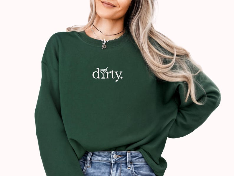 May include: A dark green sweatshirt with a white graphic of a martini glass and the word "dirty."