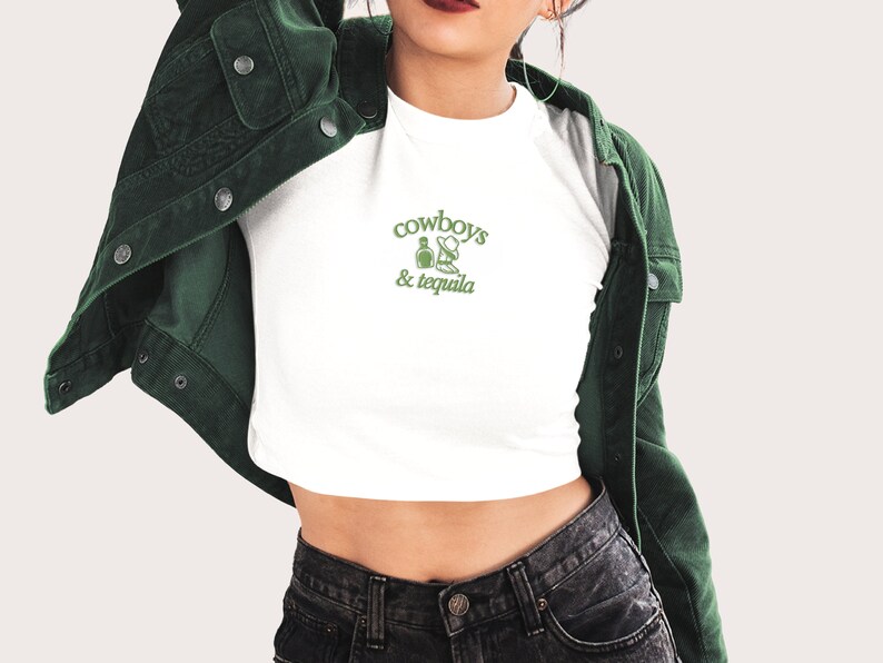 a woman wearing a crop top and jean shorts
