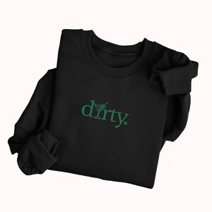 May include: Black sweatshirt with a green embroidered design that says "dirty" with a martini glass graphic.