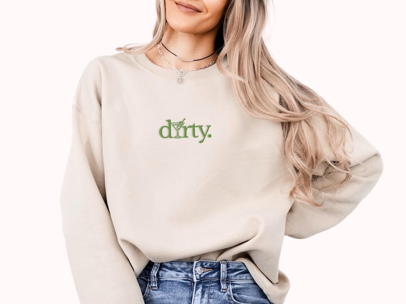 May include: A beige sweatshirt with a green embroidered design that says "dirty."