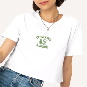 a woman wearing a cowboy's and tequila t - shirt