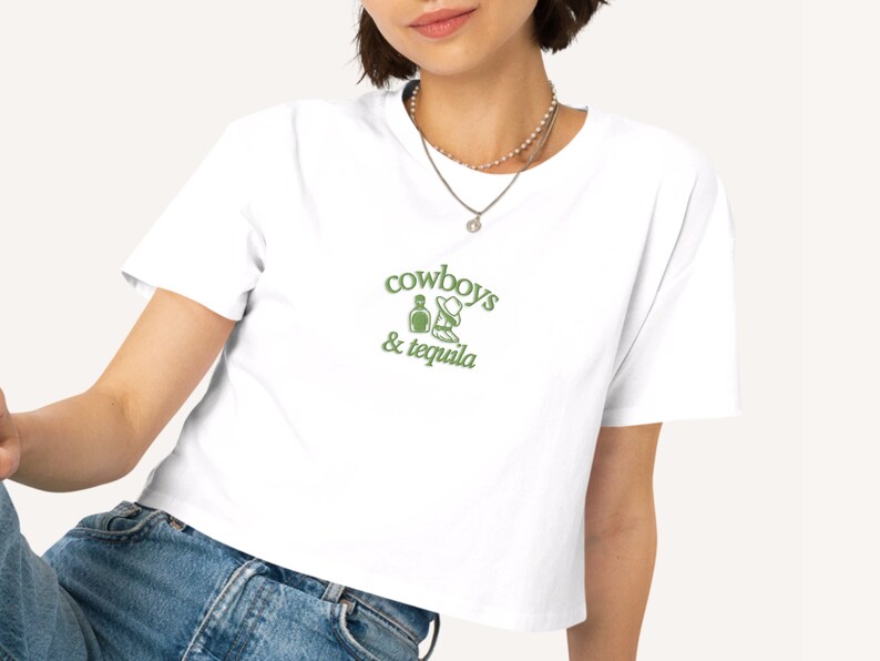 a woman wearing a cowboy's and tequila t - shirt