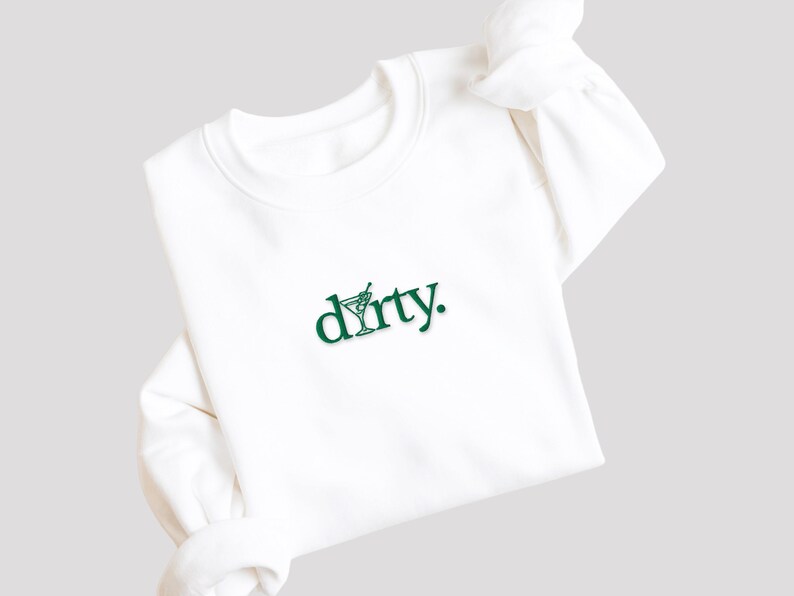 May include: White sweatshirt with a green graphic of a martini glass and the word "dirty."