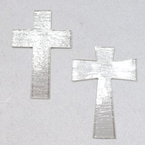 May include: Two silver-colored metal crosses. The crosses are simple in design and have a brushed finish.