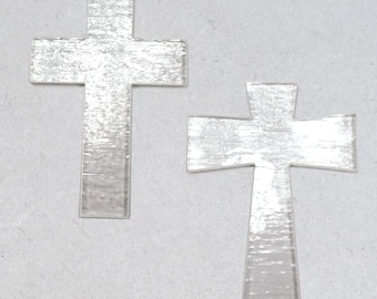 May include: Two silver-colored metal crosses. The crosses are simple in design and have a brushed finish.