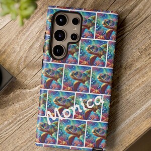 May include: A colorful phone case with a repeating pattern of sea turtles swimming in a vibrant underwater scene. The case has a white name "Monica" printed on it.
