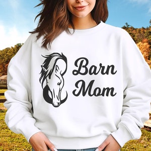 May include: White sweatshirt with a black horse head silhouette and the text "Barn Mom" in black.