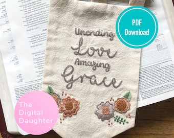 May include: Embroidered wall hanging with the text "Unending Love Amazing Grace" in brown thread on a beige fabric background. The fabric has a floral design in shades of pink, orange, and green. The text "PDF Download" is in a teal circle on the right side of the image.