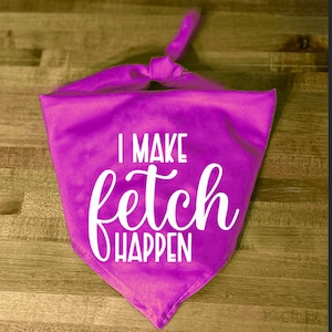 May include: A bright purple dog bandana with white text that reads "I make fetch happen".