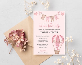 May include: Pink and brown invitation with a hot air balloon illustration. The text reads "Love is in the air" and "Join us for a Couples Shower Honoring Taylor + Travis".