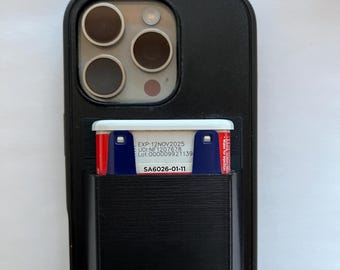 May include: A black smartphone case with a built-in card holder pocket. A small rectangular medical vial with a white cap is inserted into the pocket. The vial label reads: EXP:12NOV2025, UDI:NF1207678, Lot:000009921139, and SA6026-01-11.