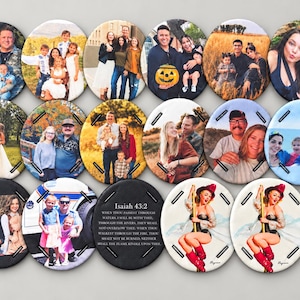 May include: A collection of fifteen circular buttons featuring various photographic prints of families, couples, and individuals, along with one button displaying the text Isaiah 43:2 and two buttons depicting a pin-up illustration.