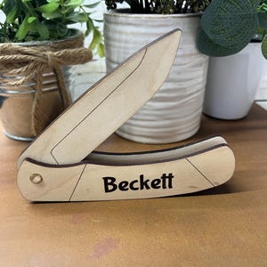 May include: A wooden pocket knife with the name "Beckett" engraved on the handle.