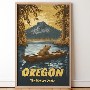 Op de afbeelding: Een ingelijste kunstprint met een bever in een houten boot op een meer. De achtergrond toont een berg, bomen en de tekst "OREGON The Beaver State" in geel en wit.