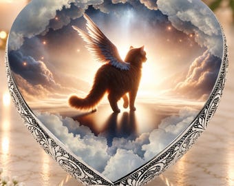 May include: A heart-shaped decorative plaque featuring a central image of a brown cat with large feathered wings standing amidst fluffy white clouds and a glowing golden sunset sky, framed by an ornate silver-toned metal border with intricate patterns.