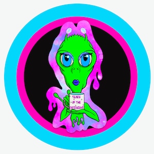 May include: A green alien with blue eyes and pink glitter eyeshadow is holding a white coffee mug with the text "Tears of the Patriarchy" in pink letters. The alien is surrounded by a pink and purple galaxy-like background.