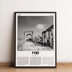 May include: Black and white framed print featuring an ancient city scene with an archway and columns. The word "TYRE" is prominently displayed, with text in multiple languages. The print is a historical travel-themed art piece.