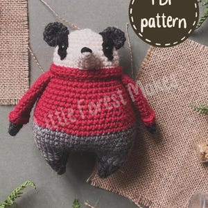 May include: A crocheted panda toy wearing a red sweater and gray pants. The panda has a white face with black ears and eye patches. A circular brown badge in the upper right corner contains the white text PDF pattern. The text Little Forest Maker is visible across the center of the image.