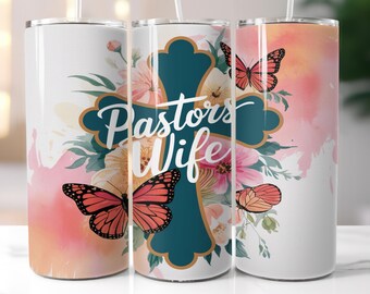May include: A white tumbler with a teal cross and the words "Pastors Wife" in gold lettering. The cross is surrounded by pink and yellow flowers and butterflies.