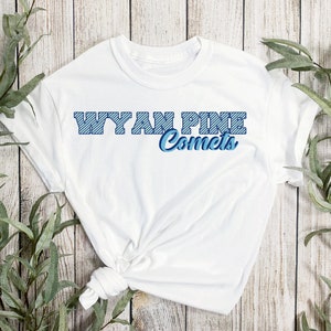 May include: White t-shirt with a blue and white striped design that says "Wyan Pine Comets" in blue lettering.