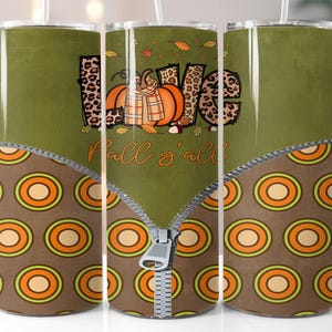 May include: Three stainless steel tumblers with a fall-themed design. The tumblers feature a zipper design with a brown and orange pattern on the bottom half. The top half of the tumblers features a green background with a pumpkin, leaves, and the text "Fall y'all".