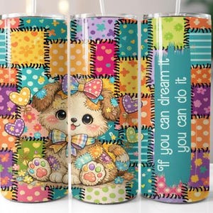 May include: A colorful tumbler featuring a cartoon puppy with a bow, surrounded by hearts and flowers. The design incorporates a patchwork pattern in various colors. Text on the side reads "If you can dream it, you can do it."