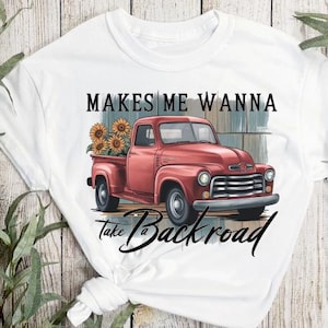 May include: White t-shirt with a red vintage pickup truck with sunflowers in the bed. The text "Makes me wanna take a backroad" is printed on the shirt.