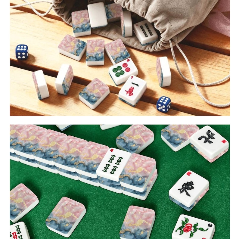 May include: A set of Mahjong tiles featuring a pink and blue marbled pattern with gold accents on the back. Some tiles display traditional black, red, and green Chinese characters and symbols. Two small blue dice are included with the game set.