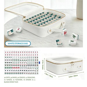 May include: A white rectangular storage case with a clear top window and gold zipper, containing mahjong tiles with green and floral patterns. The set includes 144 tiles, measuring 9.8 inches by 7.5 inches by 3.7 inches, with various character designs.