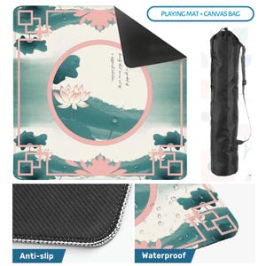May include: A square playing mat featuring a teal and pink lotus flower design with a circular frame and geometric borders, paired with a black cylindrical canvas bag. The mat has a textured black anti-slip underside and a waterproof surface.