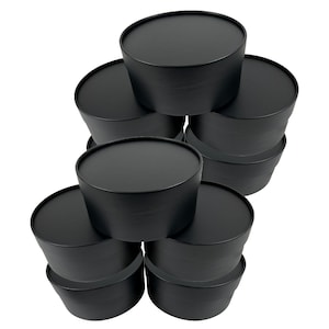 May include: A stack of black round containers with lids. The containers are cylindrical with a slightly tapered shape. The lids are flat and fit snugly on top. The containers are made of a matte black material and are arranged in a visually appealing stack.